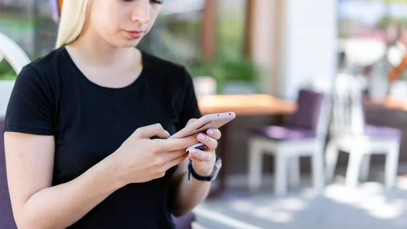 Person dictating into iPhone with text appearing on screen in real time